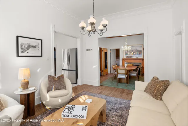 a living room with furniture and a chandelier