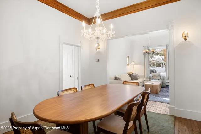 a view of a dining room with furniture and chandelier