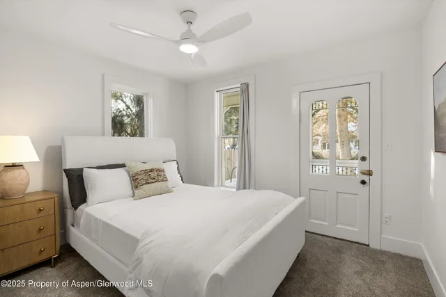 a spacious bedroom with a bed and a window