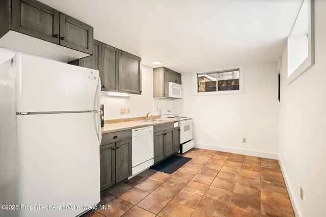a kitchen with a refrigerator and a sink