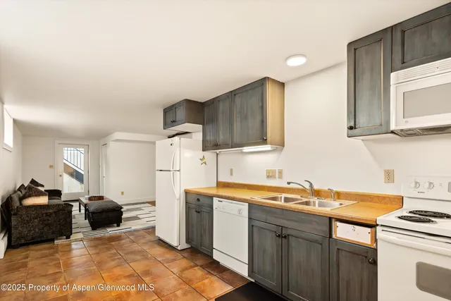 a kitchen with a sink cabinets and appliances