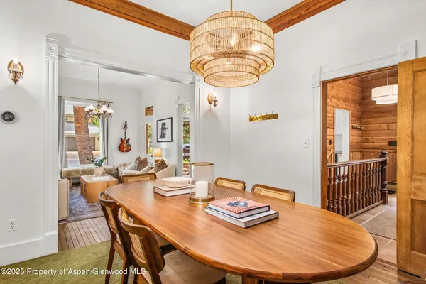 a living room with furniture a chandelier and a table