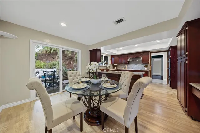 a dining room with furniture and a floor to ceiling window