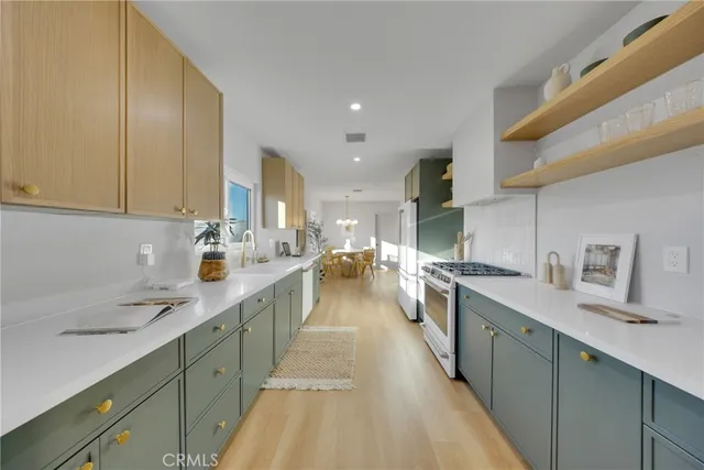 a kitchen with lots of counter top space and stainless steel appliances