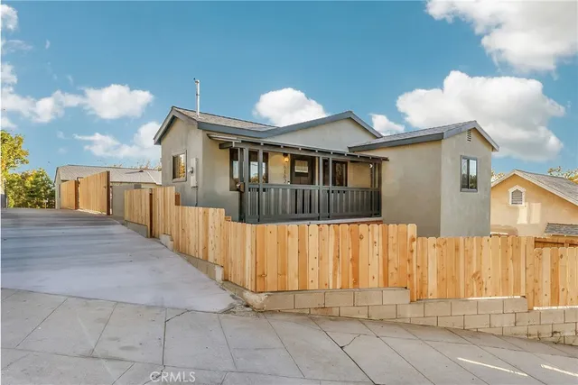 a view of a house with wooden fence