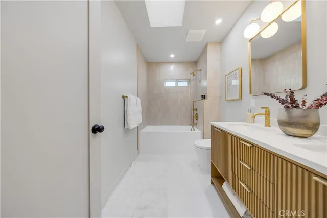 a bathroom with a bathtub a sink and a mirror