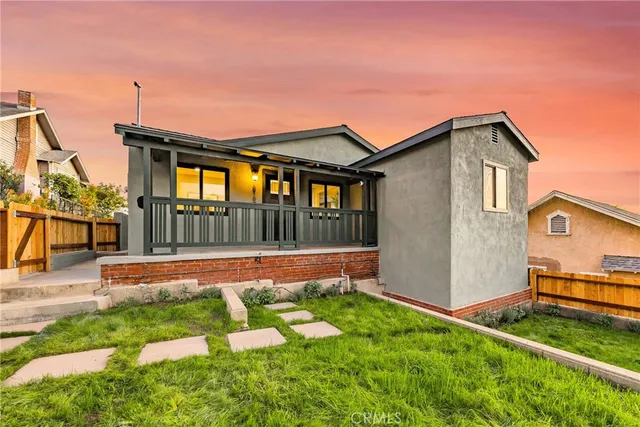 a view of a patio with table and chairs with wooden fence
