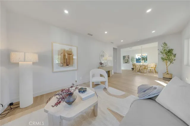 a large bedroom with a bed and a potted plant