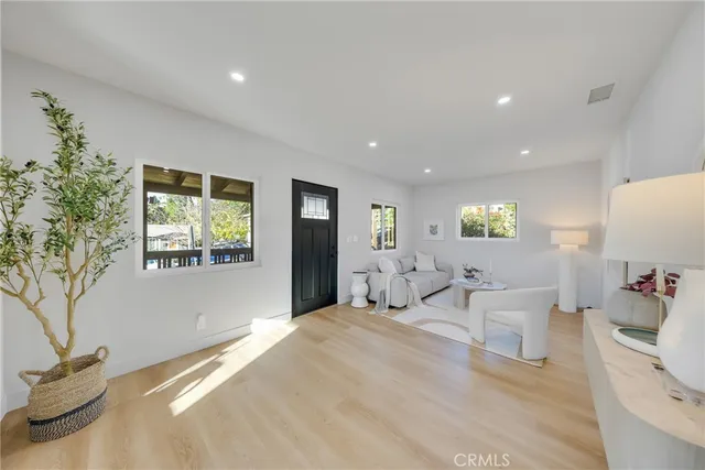 a dining room filled with furniture and a chandelier