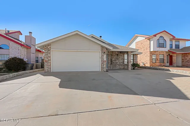 a view of multiple houses with a street
