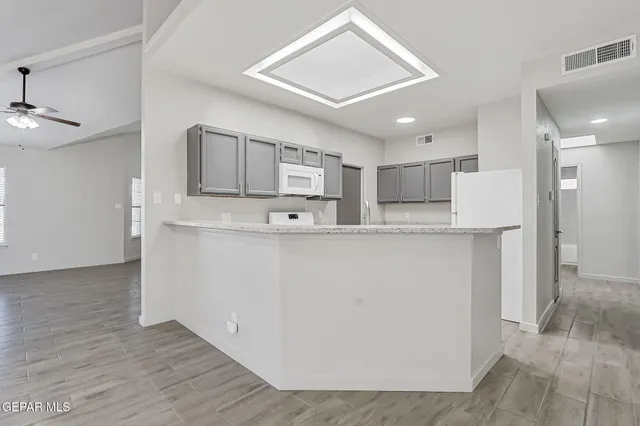 a view of kitchen with stainless steel appliances cabinets