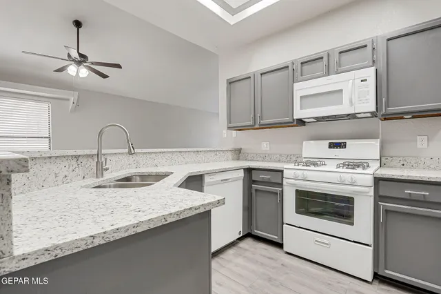 a kitchen with stainless steel appliances granite countertop a sink and a stove