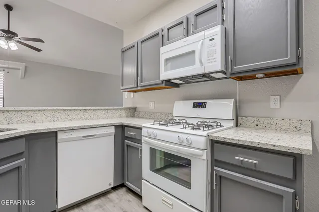 a kitchen with cabinets appliances and a sink