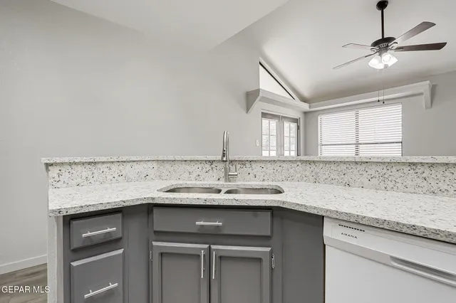 a kitchen with stainless steel appliances granite countertop a sink and cabinets