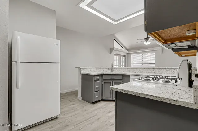 a kitchen with a sink cabinets and a refrigerator