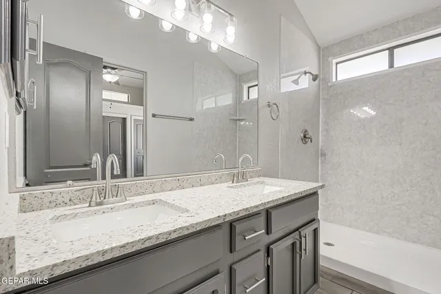 a bathroom with a granite countertop sink mirror and double