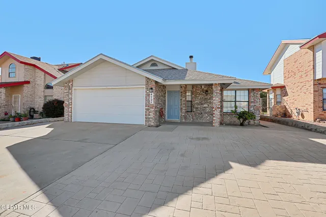 a view of a white house with a outdoor space