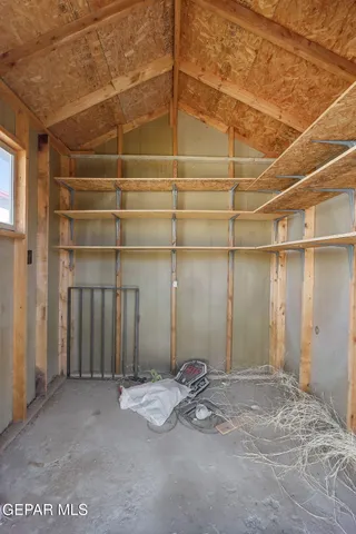 a view of a room with wooden shelves