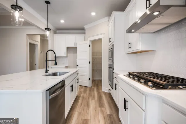 a kitchen with a sink stove and refrigerator