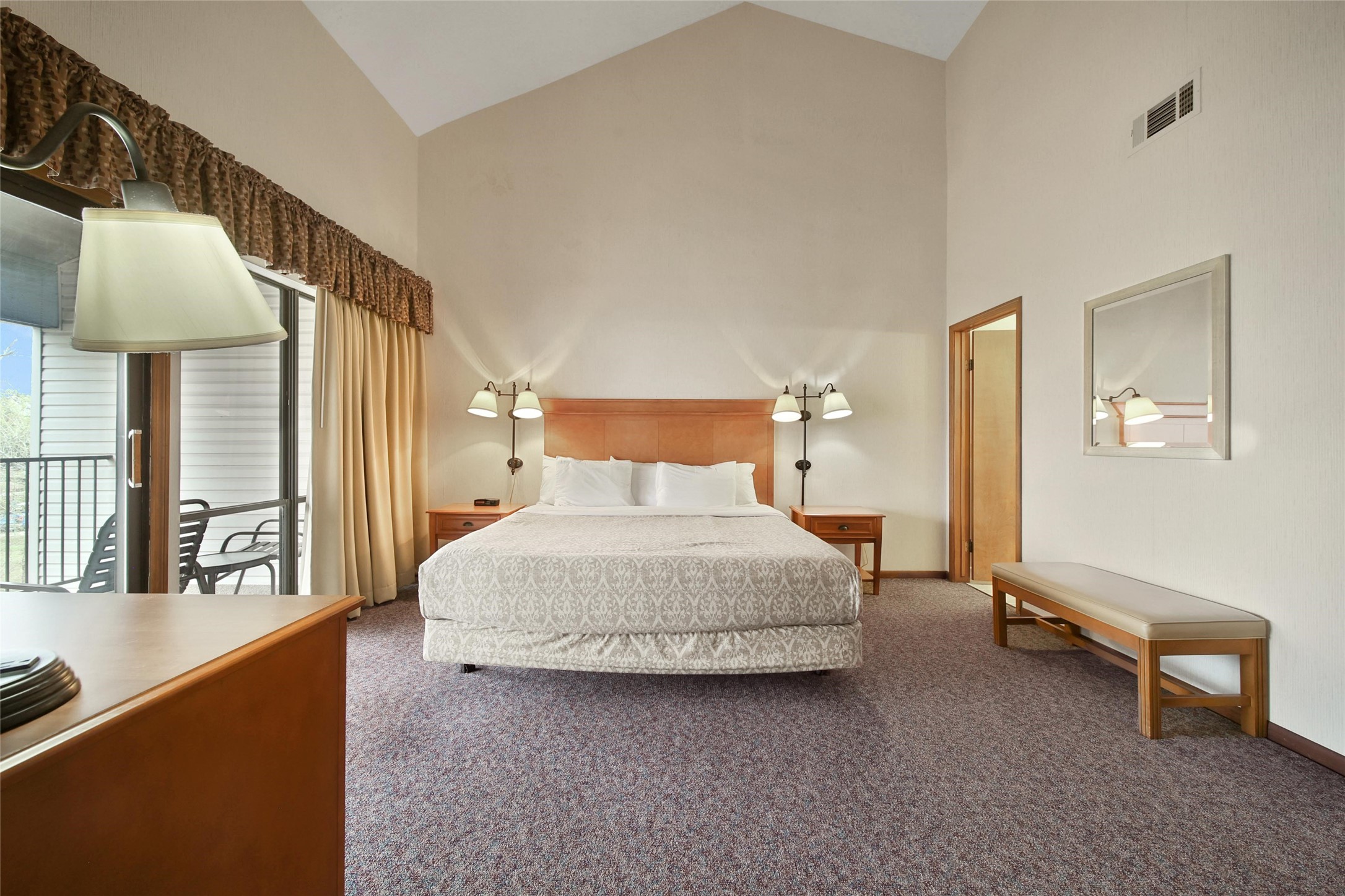 1000 April Sound Boulevard Conroe, TX 77356 - Photo 20 of 46 a bedroom with a bed and a lamp on table