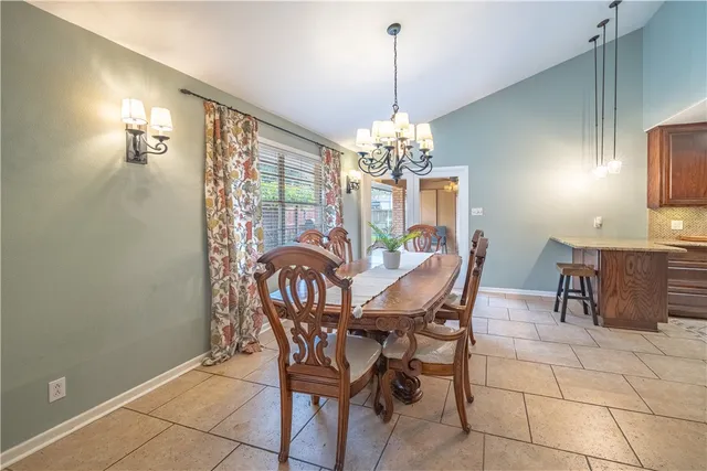 a kitchen with granite countertop a sink a stove and cabinets