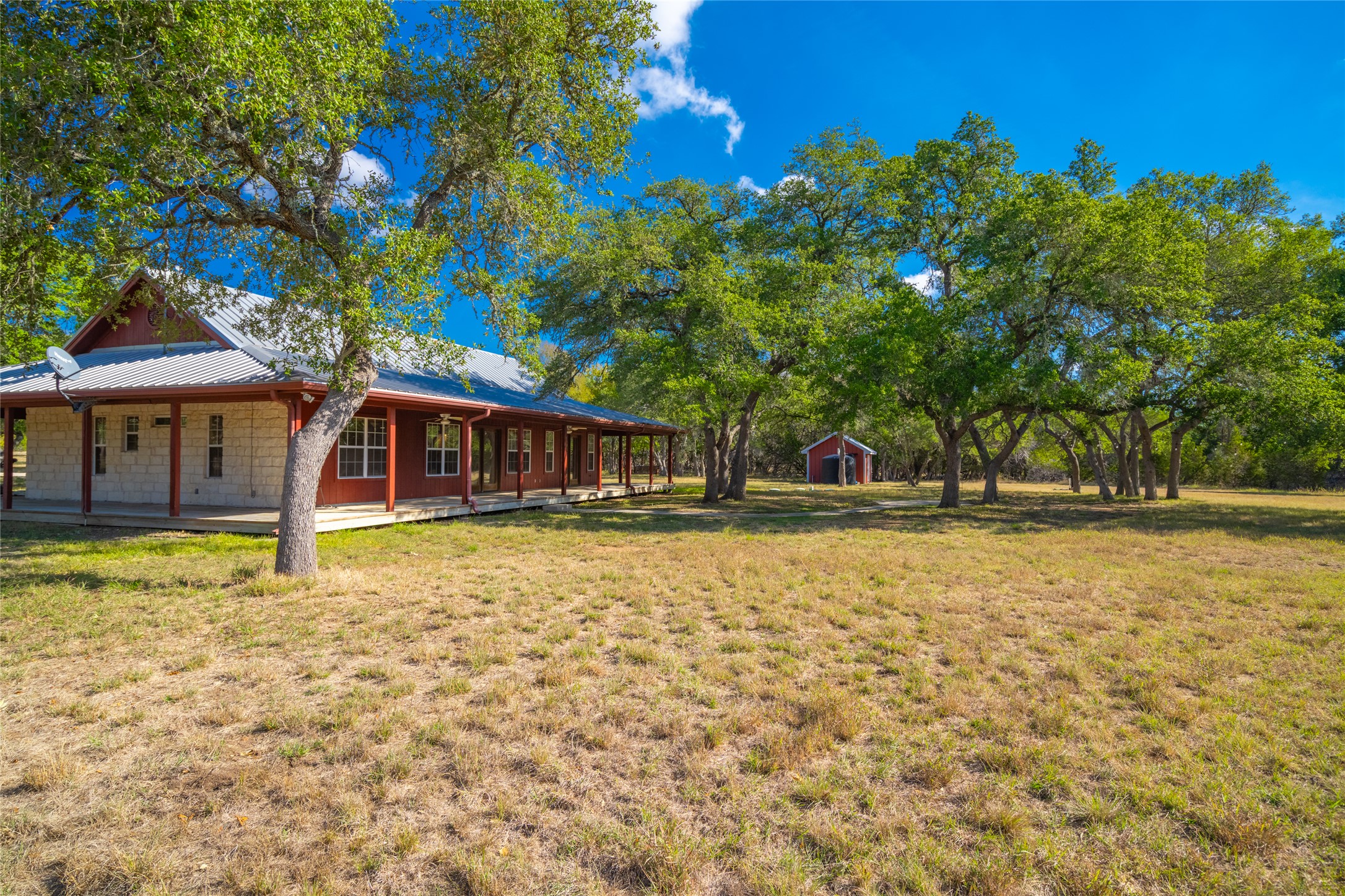 1201 Sandy Point Road Wimberley, TX 78676 - Photo 1 of 40 a house with swimming pool in front of it