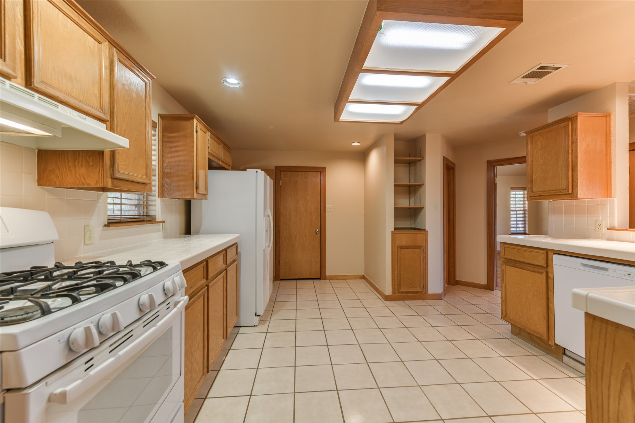 1201 Sandy Point Road Wimberley, TX 78676 - Photo 13 of 40 a kitchen with stainless steel appliances granite countertop a stove a sink and a refrigerator