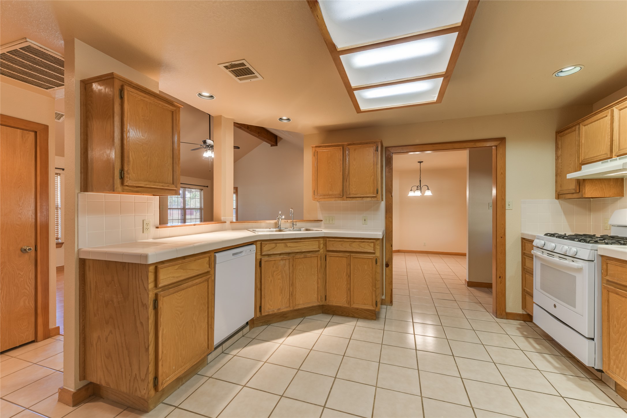 1201 Sandy Point Road Wimberley, TX 78676 - Photo 14 of 40 a kitchen with a sink a stove and cabinets