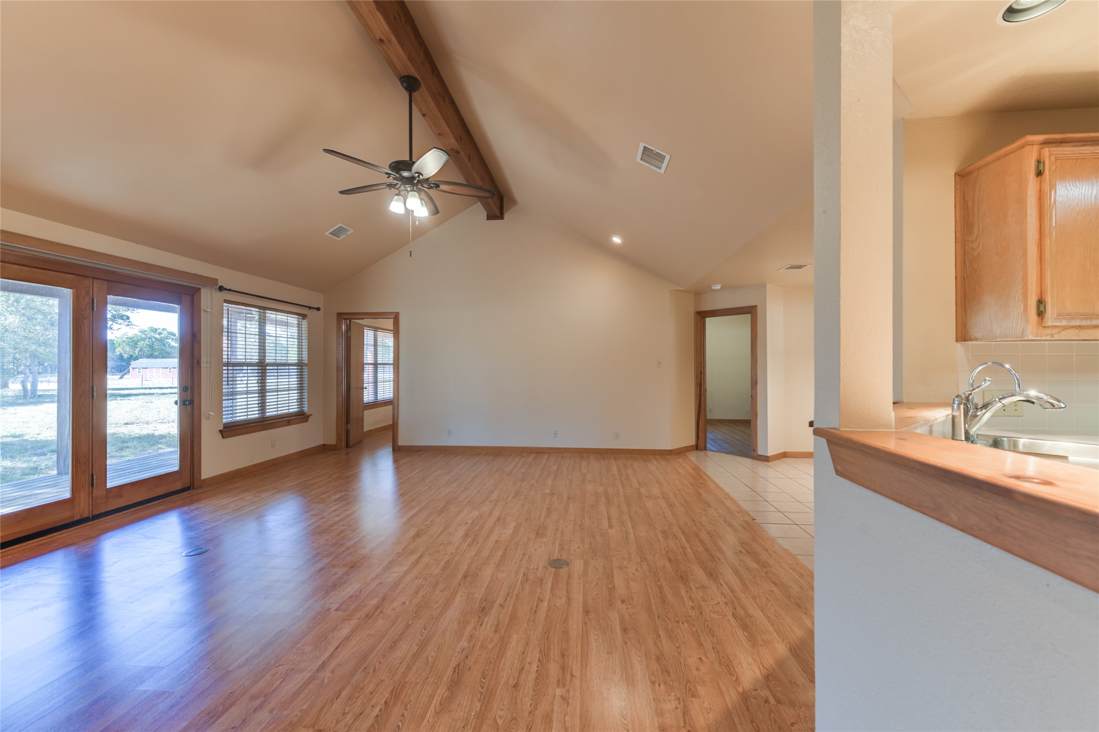 1201 Sandy Point Road Wimberley, TX 78676 - Photo 18 of 40 a view of an empty room with window and wooden floor