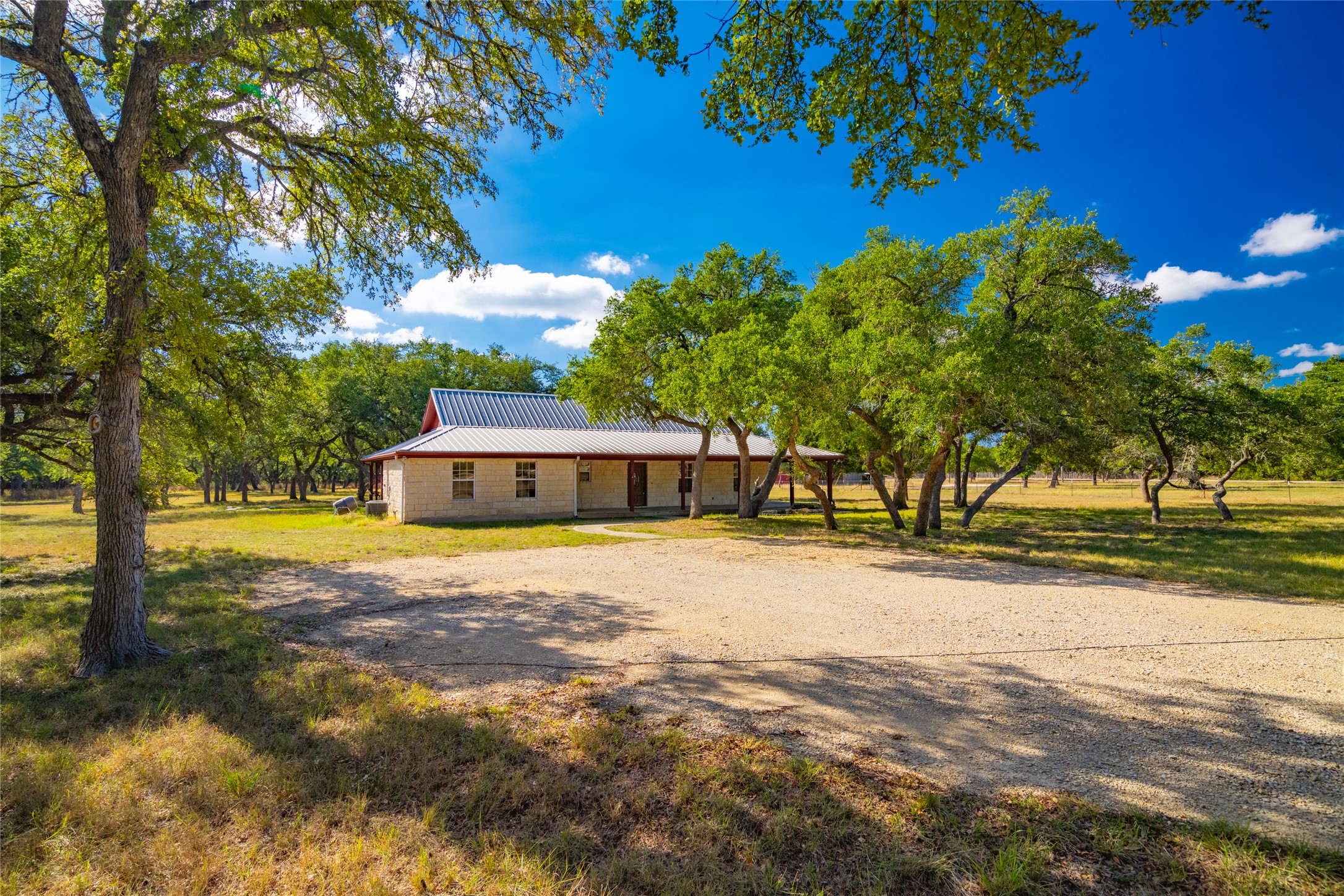 1201 Sandy Point Road Wimberley, TX 78676 - Photo 2 of 40 a view of a house with a yard