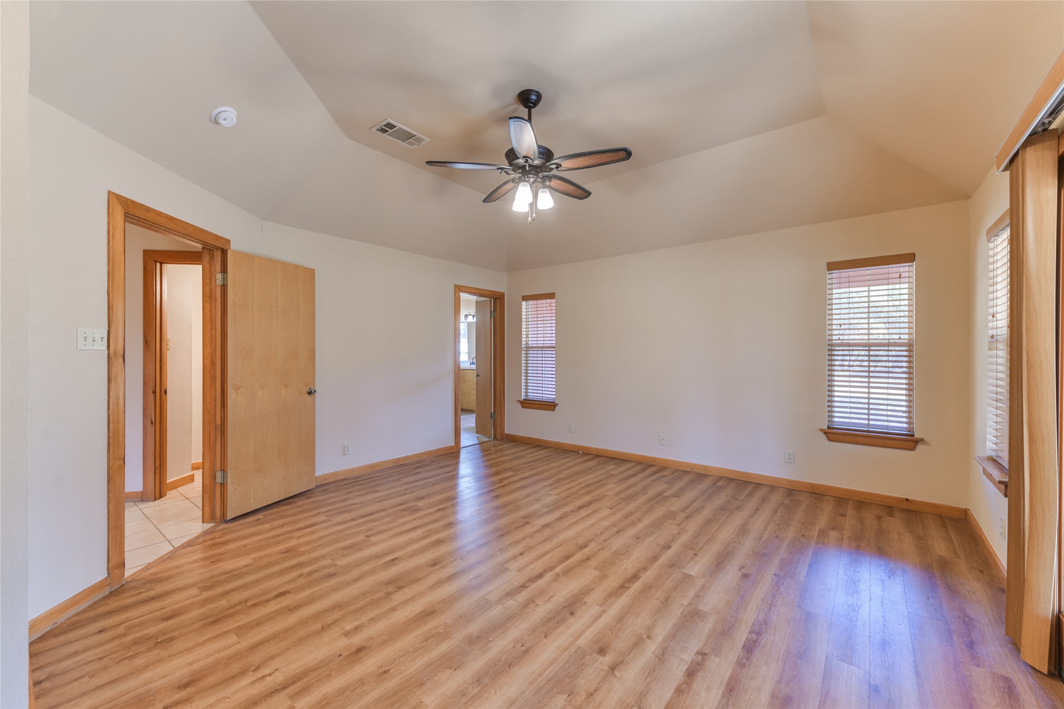 1201 Sandy Point Road Wimberley, TX 78676 - Photo 21 of 40 a view of an empty room with window and wooden floor