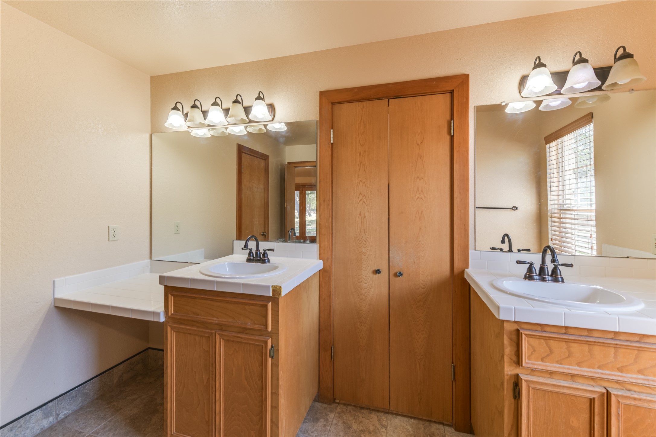 1201 Sandy Point Road Wimberley, TX 78676 - Photo 22 of 40 a bathroom with a sink vanity and a mirror