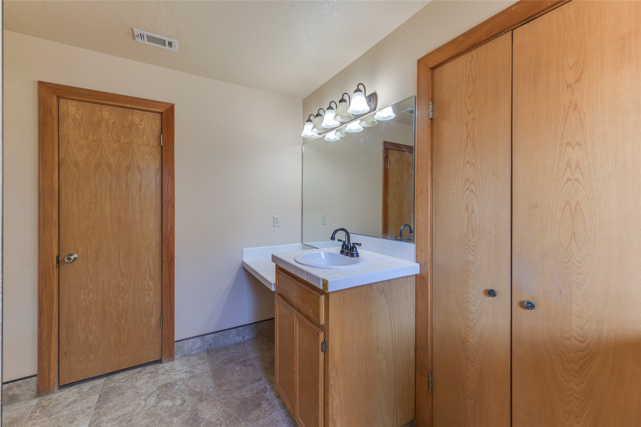 1201 Sandy Point Road Wimberley, TX 78676 - Photo 23 of 40 a bathroom with a sink a light fixture and a mirror