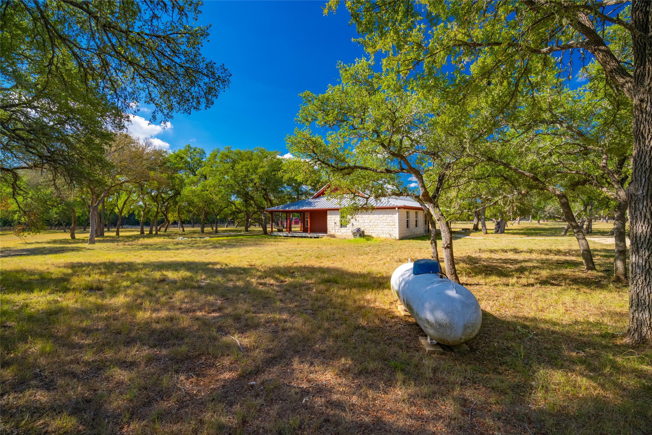 1201 Sandy Point Road Wimberley, TX 78676 - Photo 3 of 40 a front view of a house with a yard