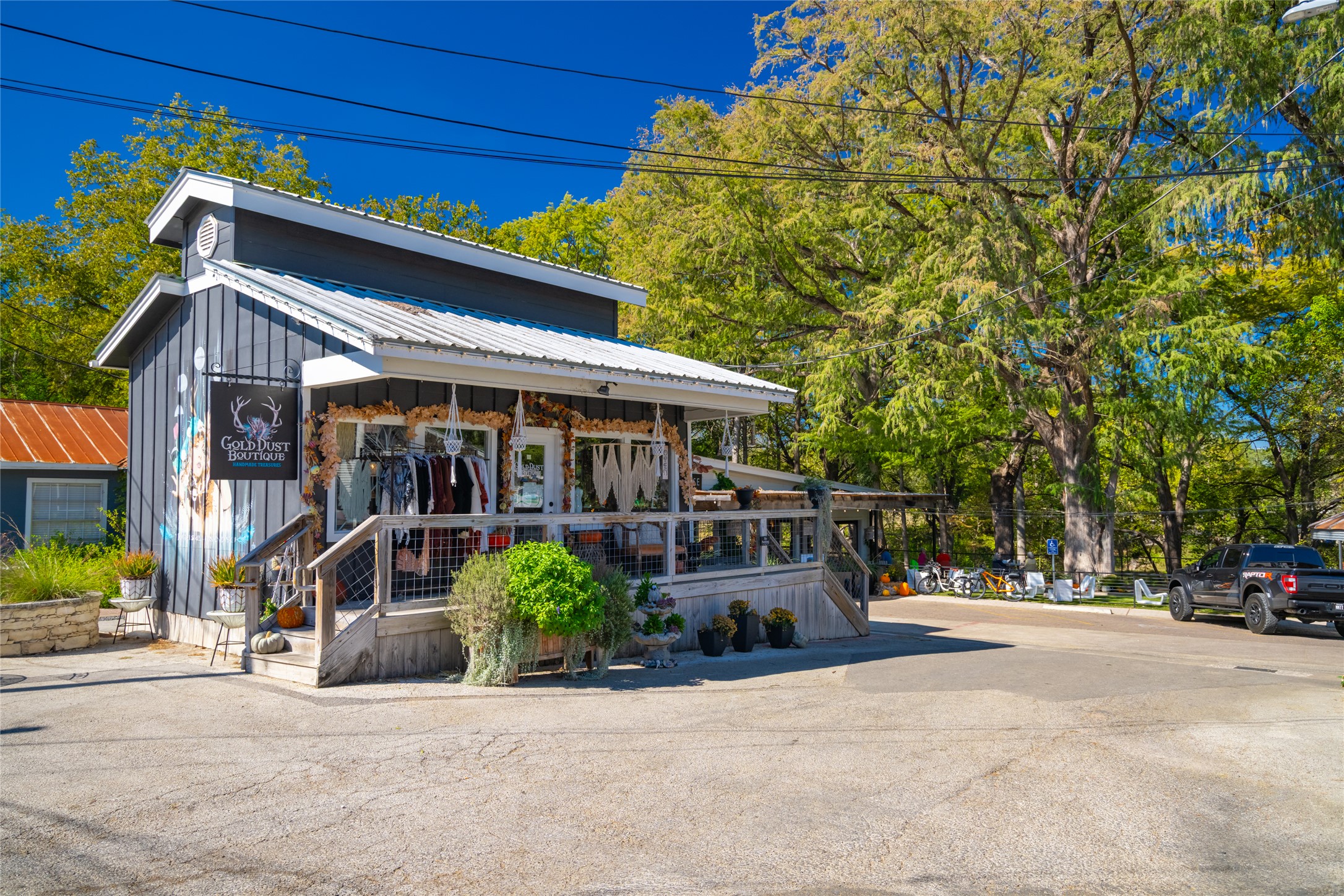 1201 Sandy Point Road Wimberley, TX 78676 - Photo 37 of 40 a front view of a house with a yard and potted plants