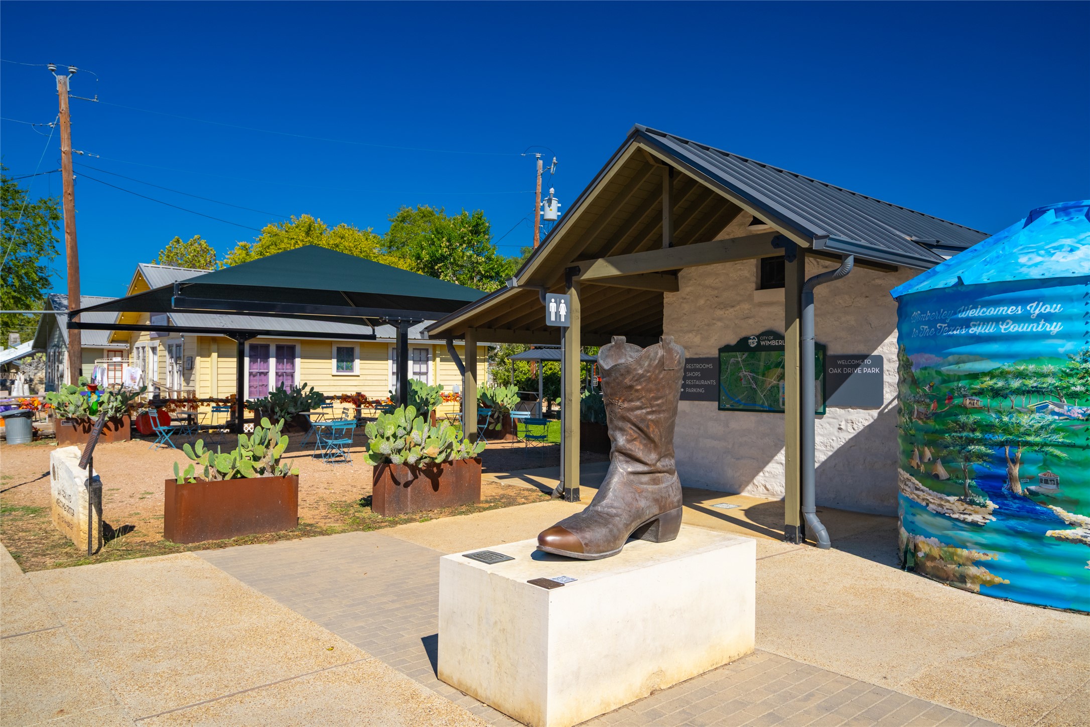 1201 Sandy Point Road Wimberley, TX 78676 - Photo 40 of 40 a view of the patio with a dining table and chairs under an umbrella