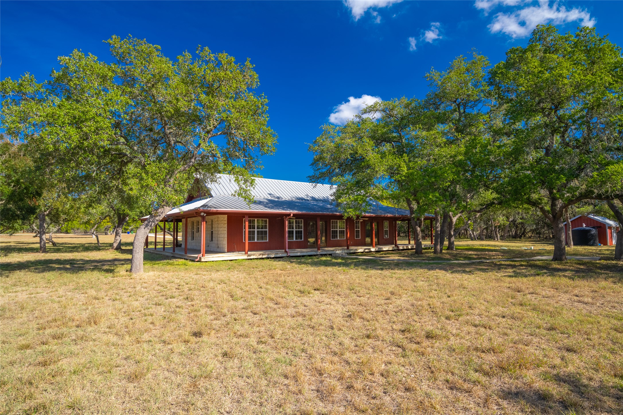 1201 Sandy Point Road Wimberley, TX 78676 - Photo 6 of 40 a front view of a house with a garden