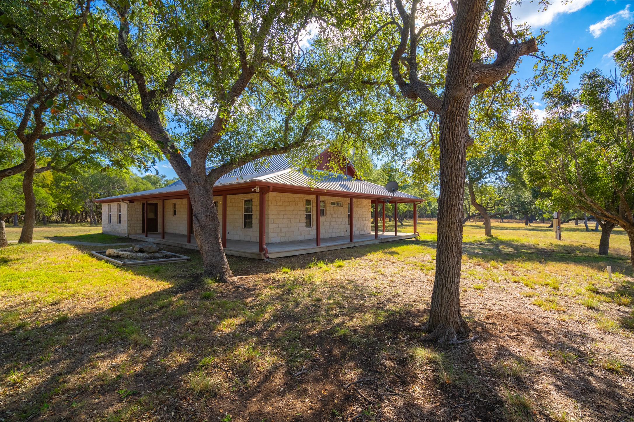 1201 Sandy Point Road Wimberley, TX 78676 - Photo 8 of 40 a house with trees in front of it