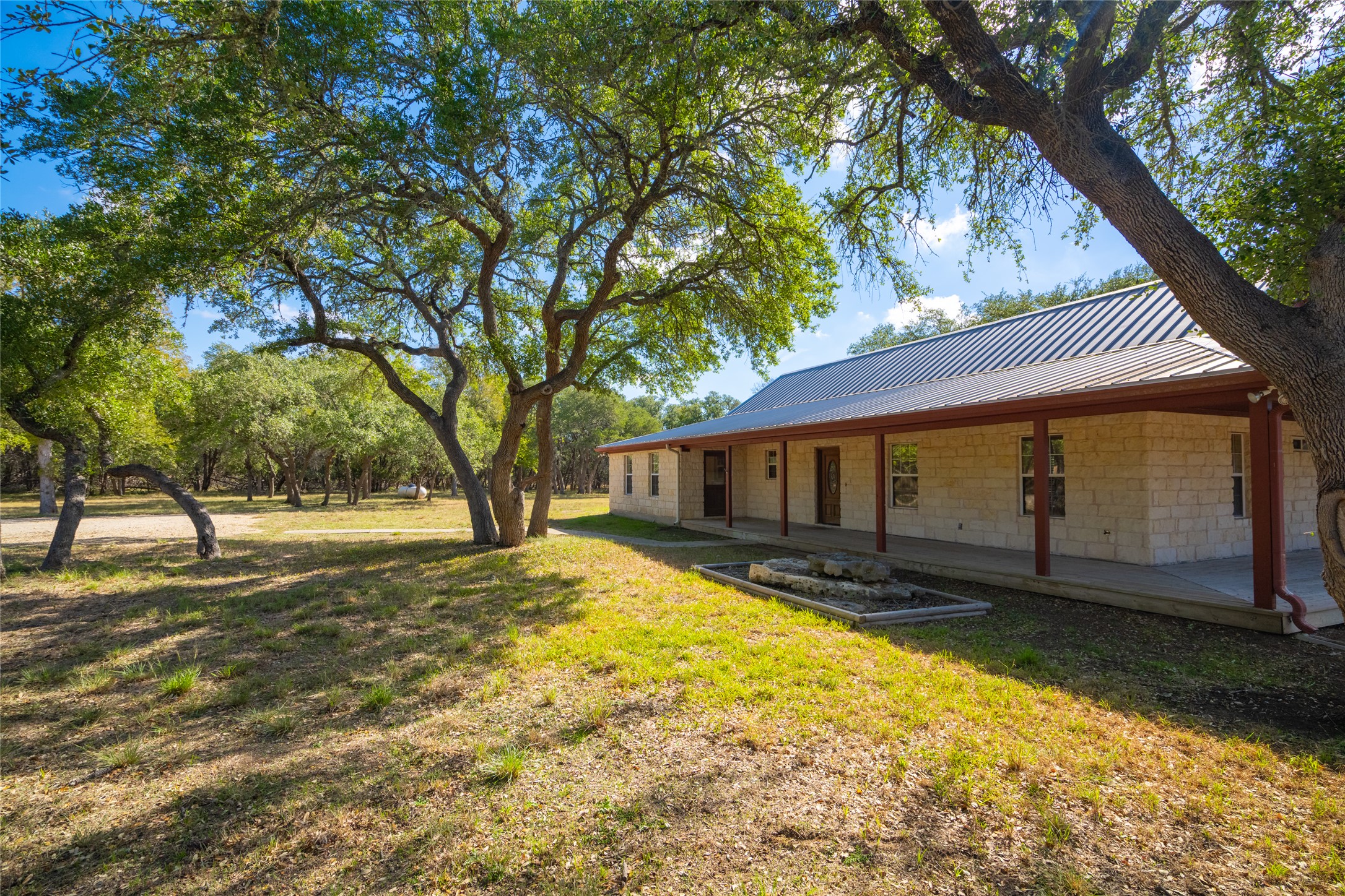 1201 Sandy Point Road Wimberley, TX 78676 - Photo 9 of 40 a view of a house with a yard