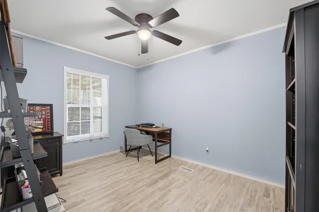 a view of a workspace with furniture and a window