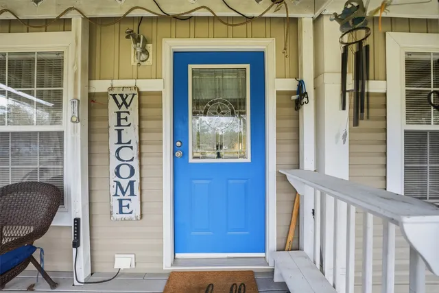 a front view of a house with glass windows and door