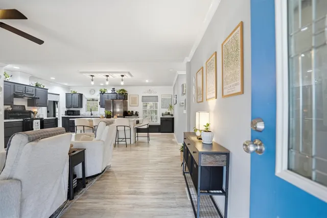 a living room with furniture a fireplace and wooden floor