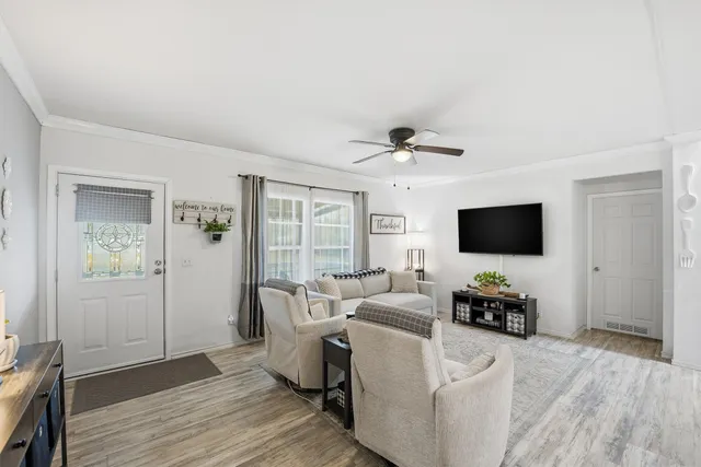 a living room with furniture and a flat screen tv