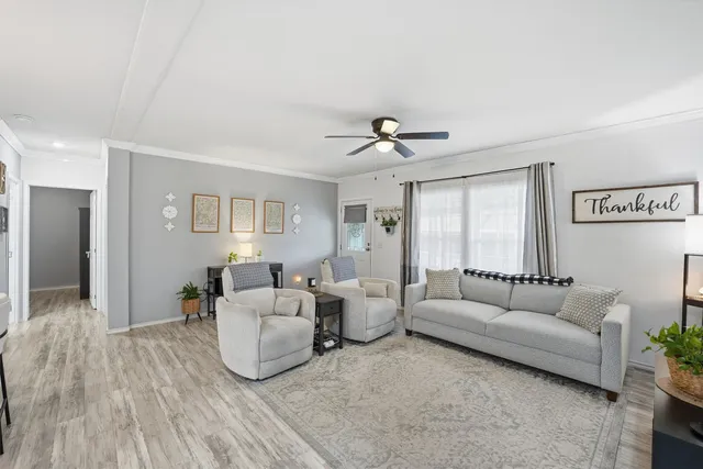 a living room with furniture and wooden floor