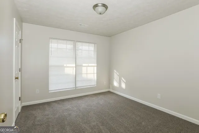 an empty room with a empty space and windows