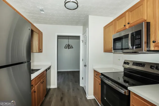 a kitchen with a refrigerator stove and microwave