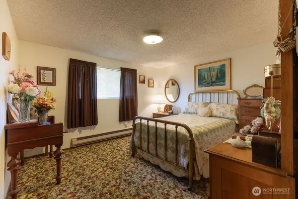 a bedroom with a bed and a couch