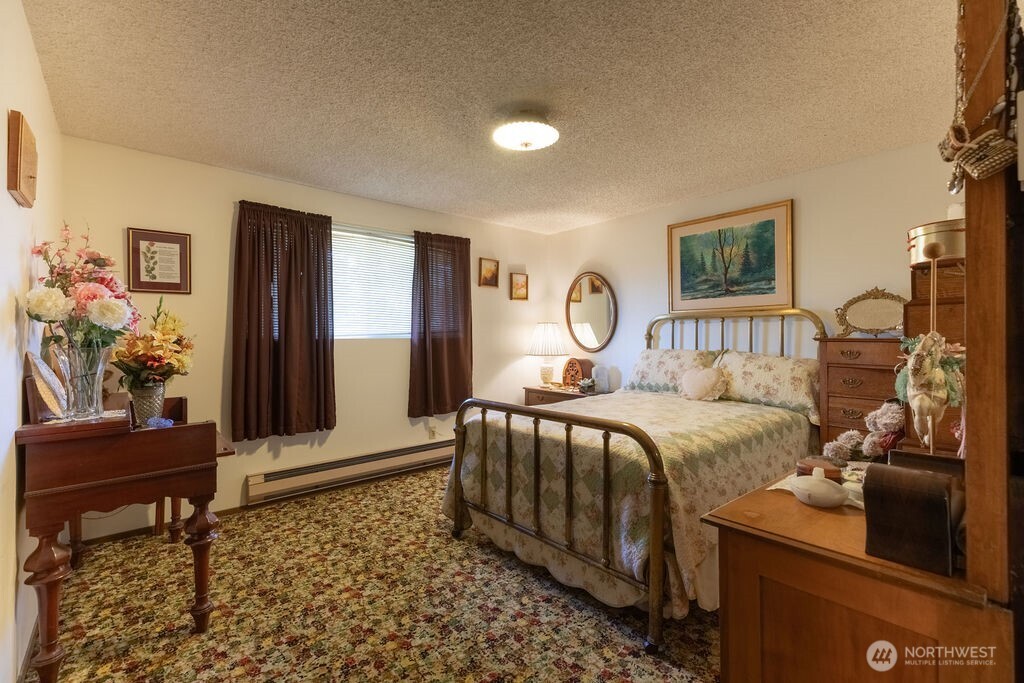 371 Flora Place Forks, WA 98331 - Photo 12 of 40 a bedroom with a bed and a couch