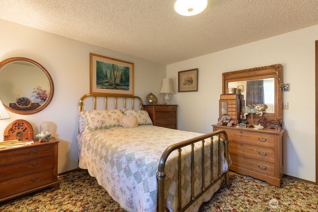 371 Flora Place Forks, WA 98331 - Photo 13 of 40 a bedroom with a bed and a dresser