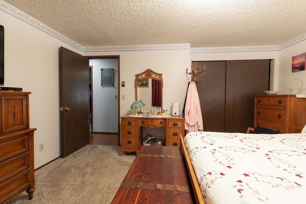 371 Flora Place Forks, WA 98331 - Photo 16 of 40 a bedroom with a bed and a dresser
